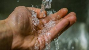 Clean water is running on the hand